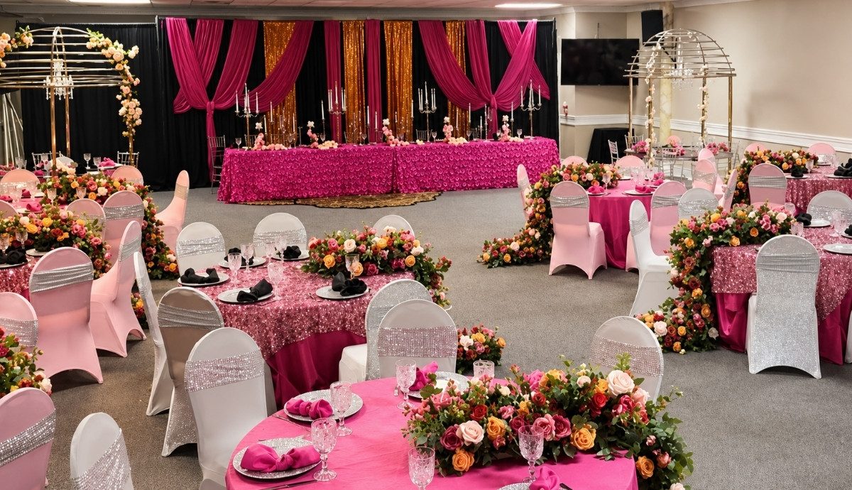 Hot pink milestone birthday ballroom with floral centerpieces and mood lighting