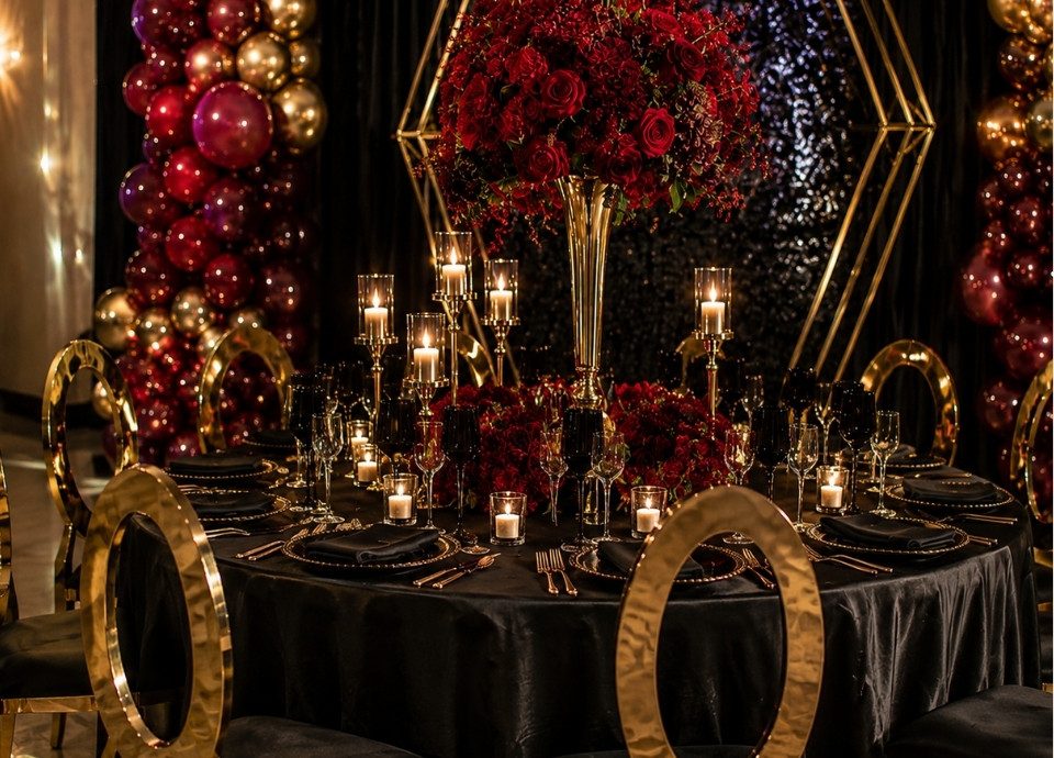 Burgundy and gold candlelit tablescape with romantic floral towers