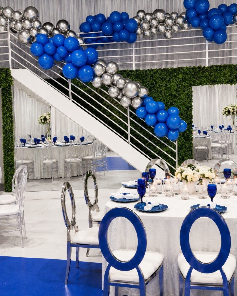 Blue and silver organic balloon garland climbing a white staircase