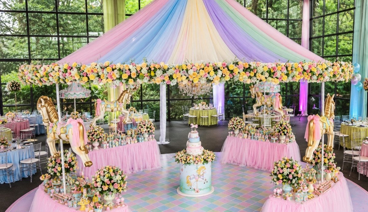 Pastel carousel dessert display surrounded by florals